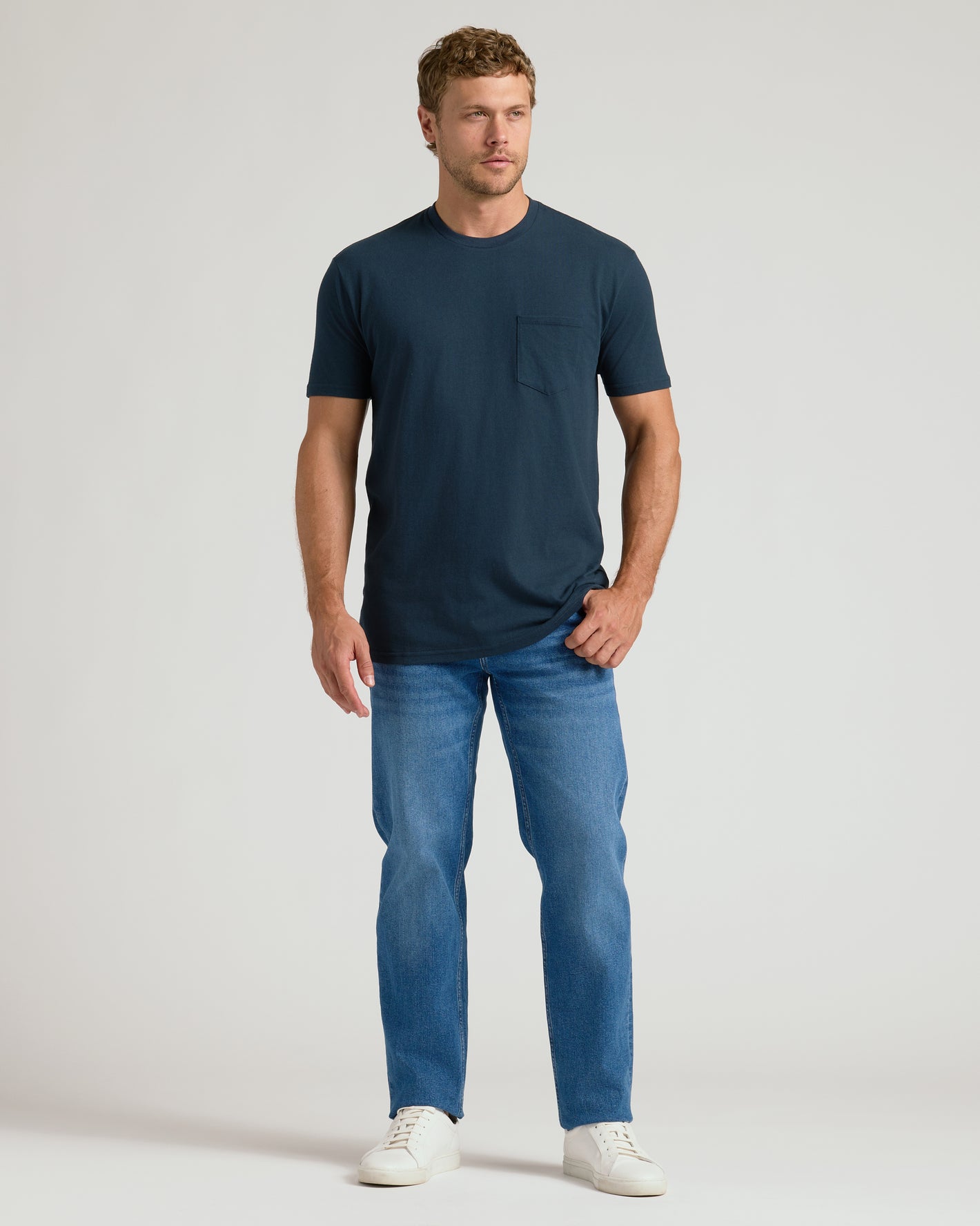 Man wearing Navy Pocket Crew Tee with jeans and sneakers.