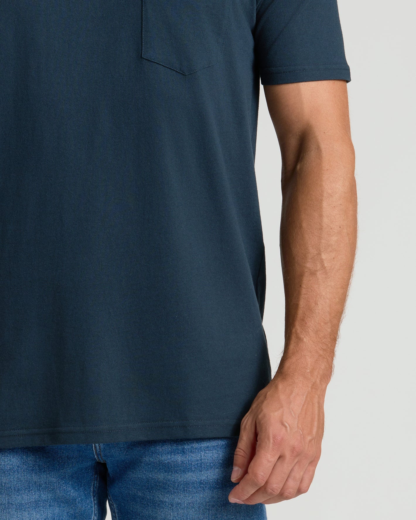 Navy Pocket Crew Tee on torso with chest pocket and jeans.