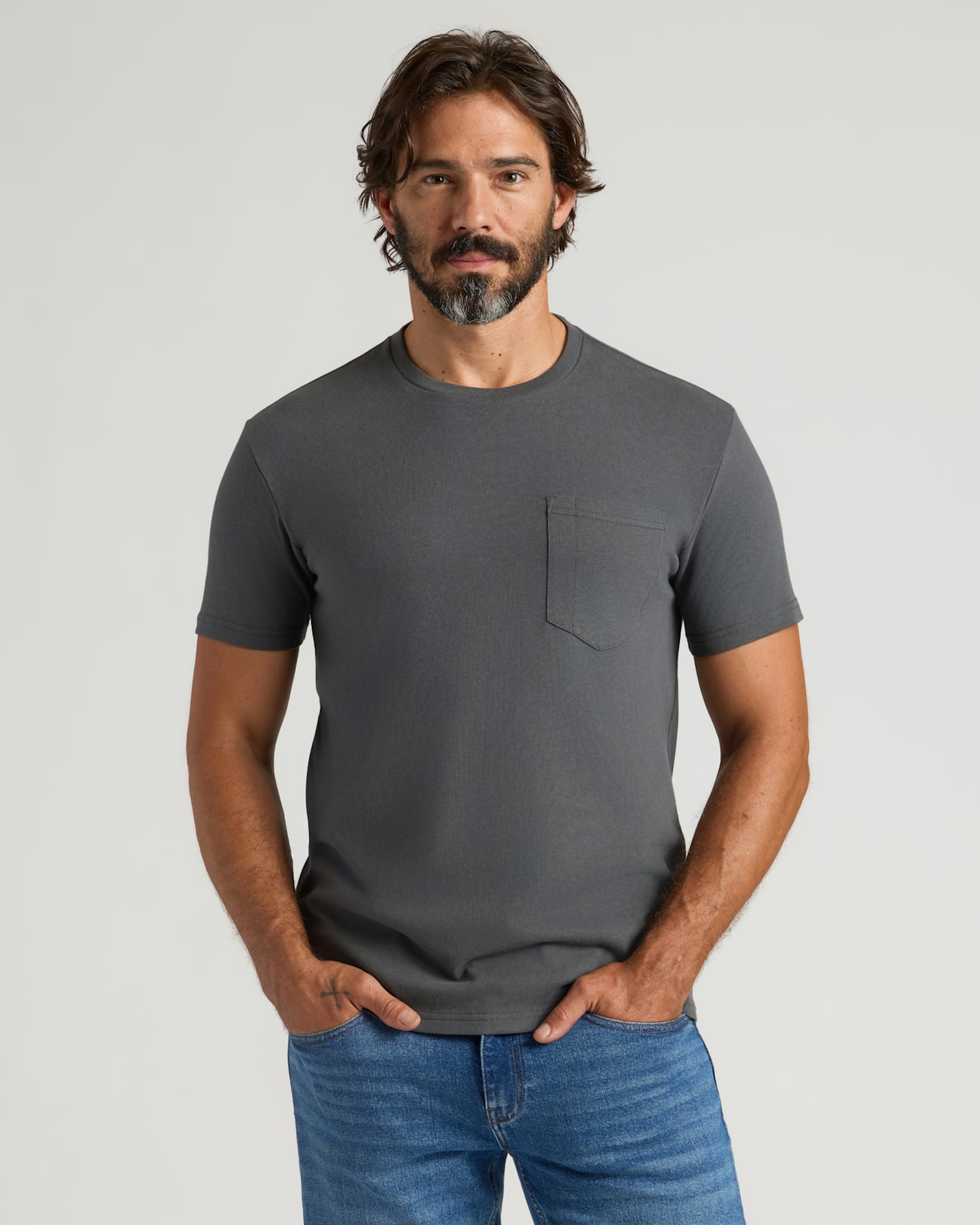 Man wearing Carbon Heavyweight Pocket Crew T-shirt with jeans.