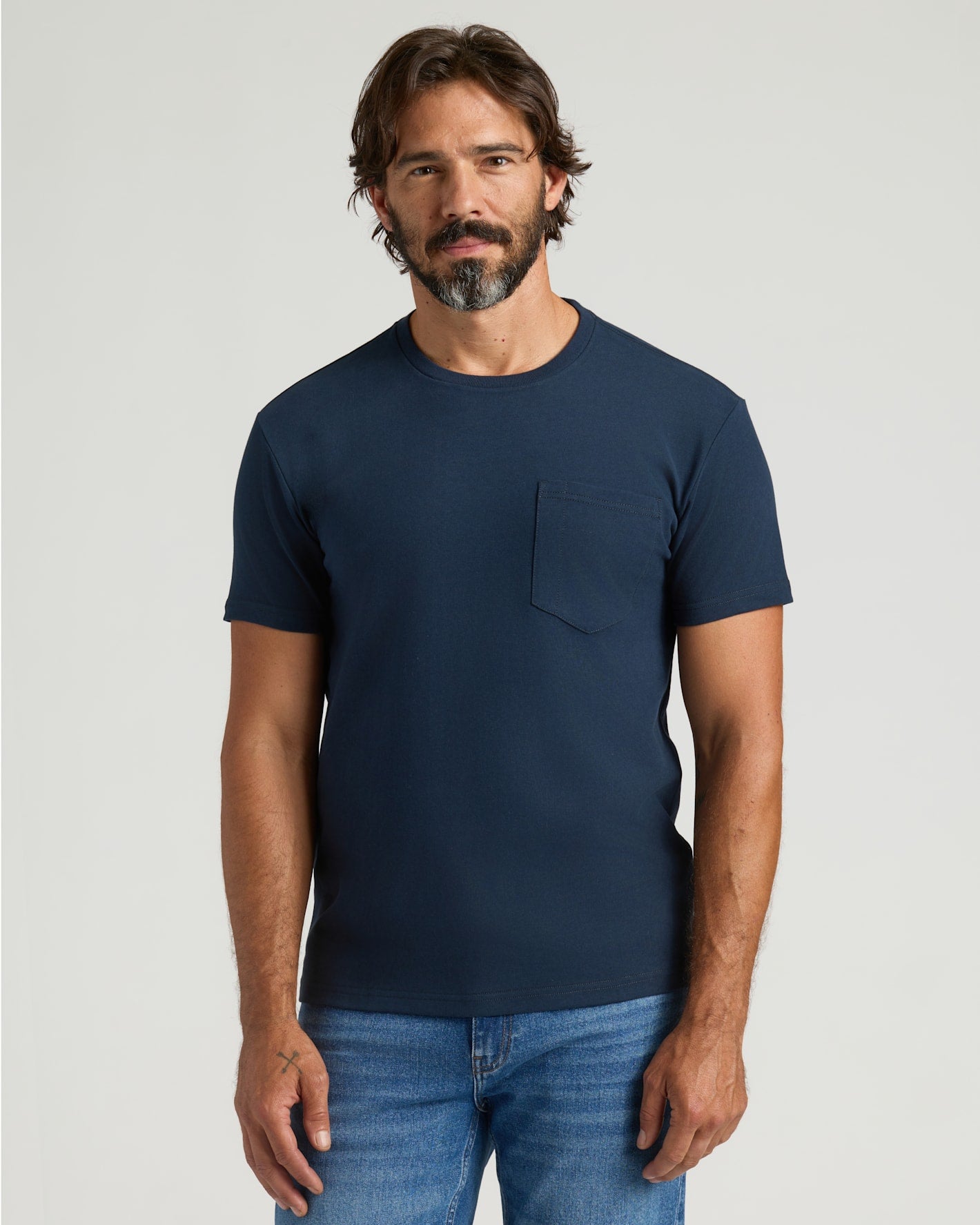 Man wearing Navy Heavyweight Pocket Crew T-shirt and jeans.