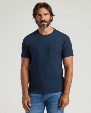 Man wearing Navy Heavyweight Pocket Crew T-shirt and jeans.