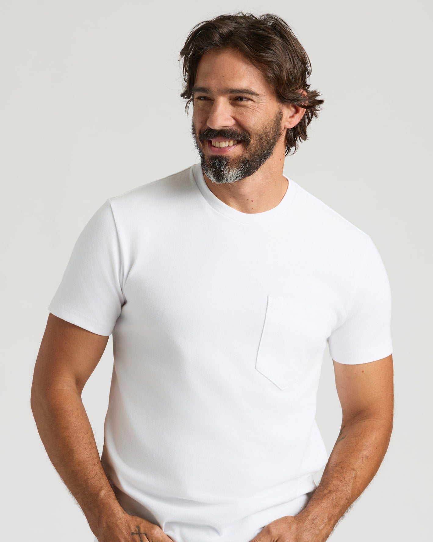 White Heavyweight Pocket Crew on smiling man, showcasing durable, soft, structured design.