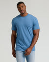 Man wearing Seasonal Tall Straight Hem T-Shirt, medium-blue, with light-wash jeans.