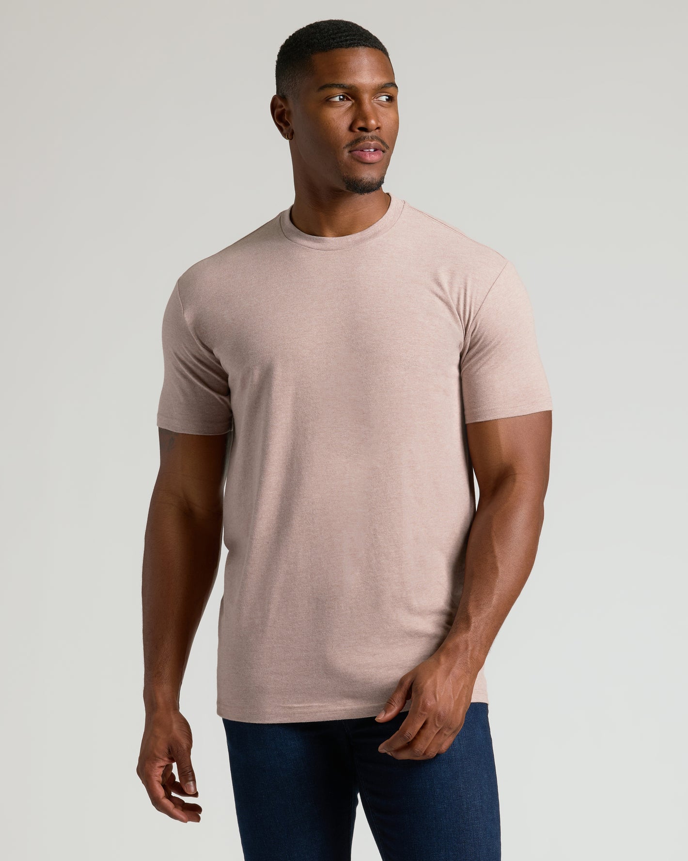 Man wearing Seasonal Tall Straight Hem T-Shirt in beige with dark jeans.