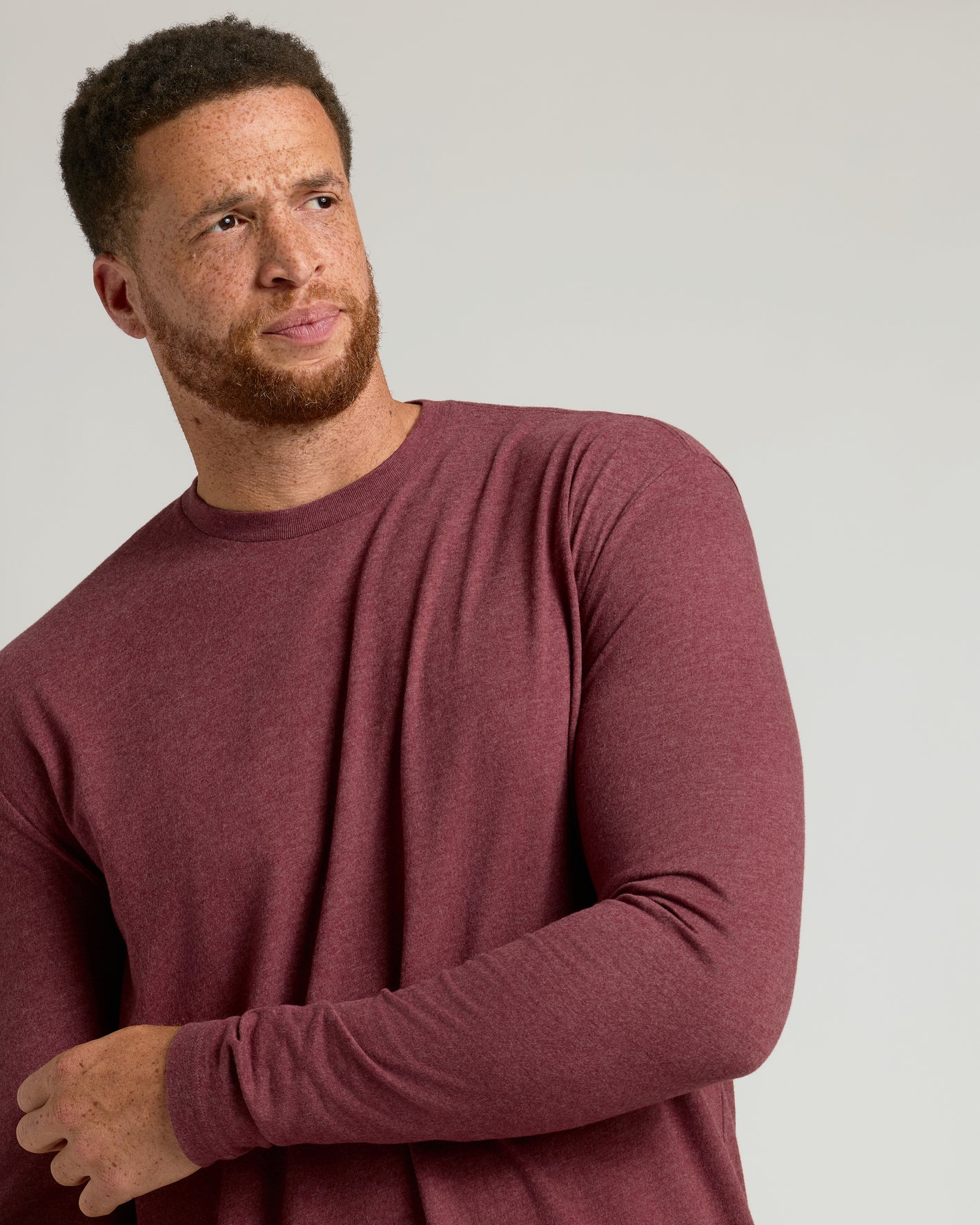 Model wearing Dark Heather Clovewood Tall Long Sleeve T-Shirt, adjusting sleeve.