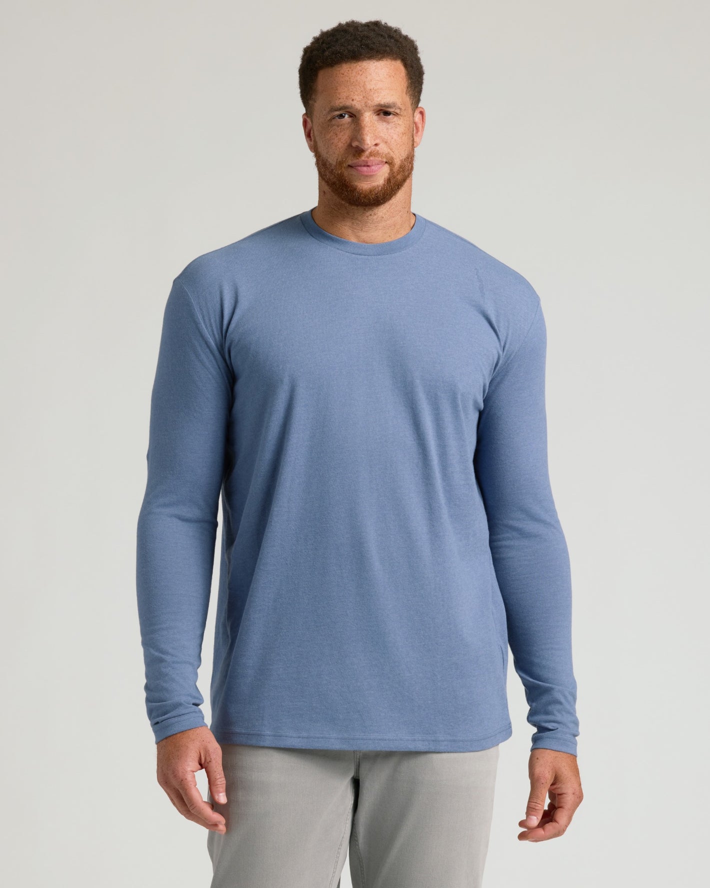 Model wearing Seasonal Tall Classic Long Sleeve Crew, blue shirt, gray pants.