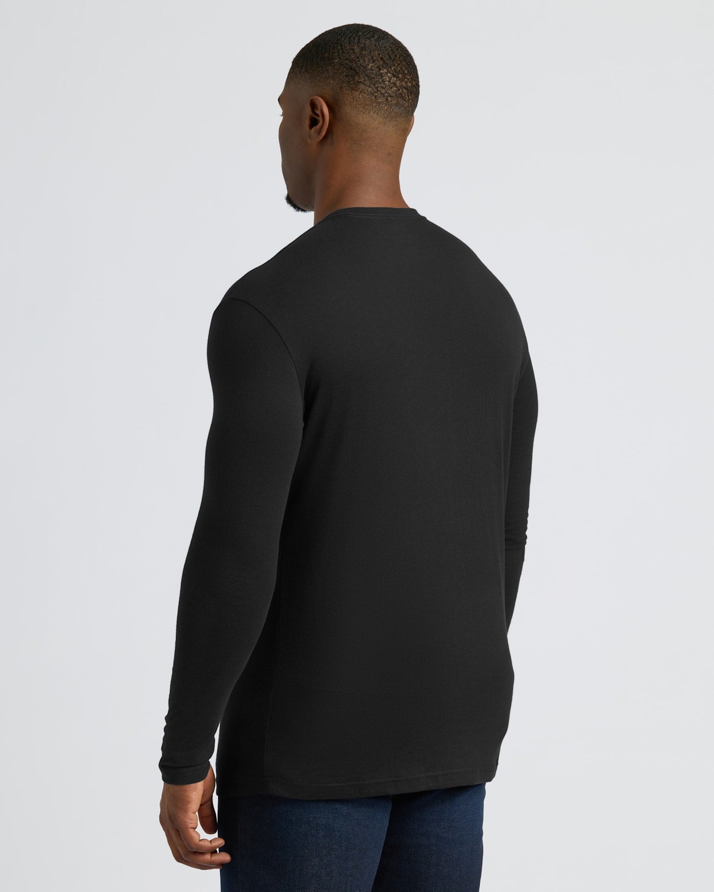 Back view of model in All Black Tall Long Sleeve Crew.