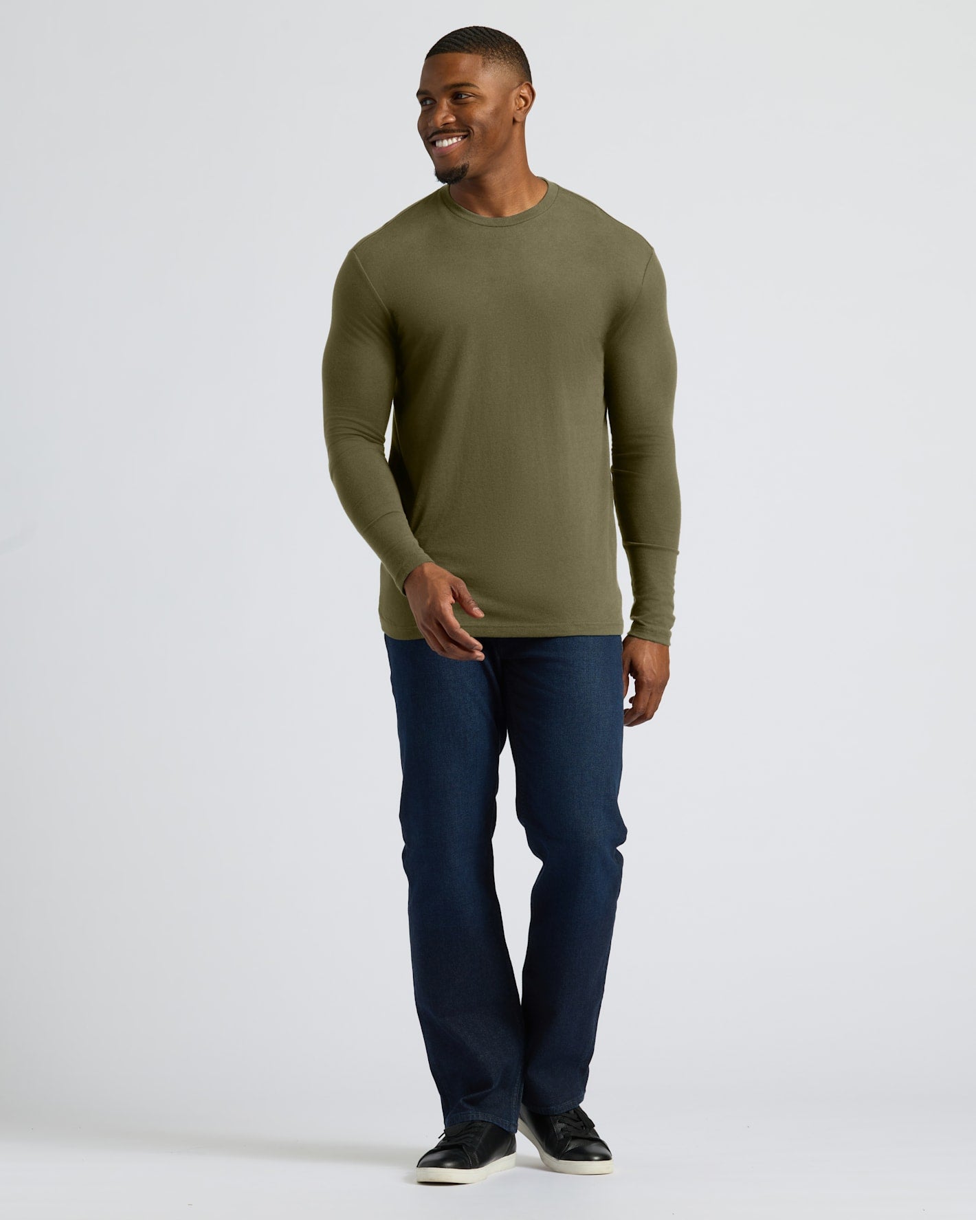Military Green Tall Long Sleeve T-Shirt on model, smiling, hand extended.
