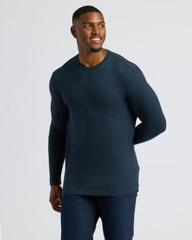 Man wearing a dark blue long-sleeve shirt against a light gray background