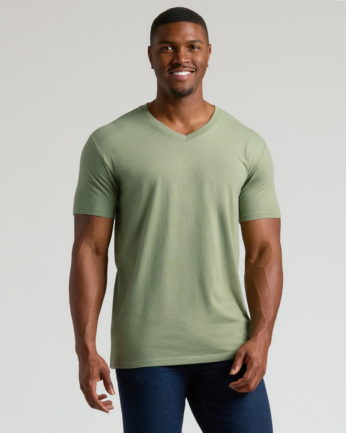 Fit man wearing Seasonal Tall Classic V-Neck in light olive-green.