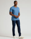 Man wearing Dark Heather Blue Lake Tall Classic V-Neck with jeans and sneakers.