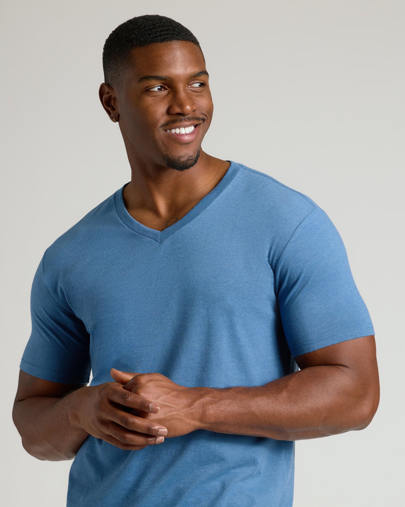 Young man in Dark Heather Blue Lake Tall Classic V-Neck, smiling.
