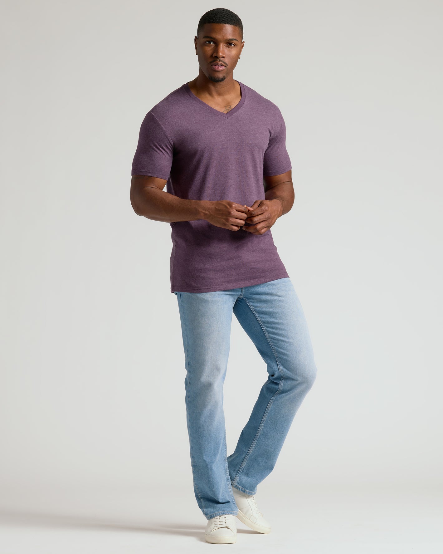 Male model wearing Dark Heather Plum Tall Classic V-Neck and light jeans.