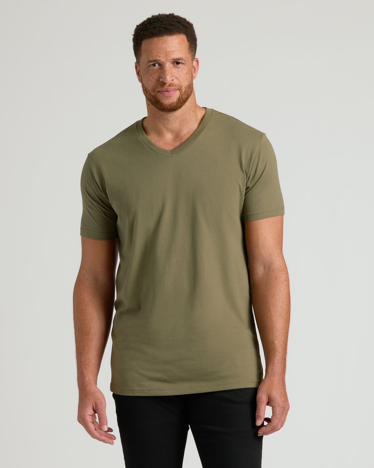 Man wears Military Green Tall Short Sleeve Classic V-Neck, showcasing its tailored fit.