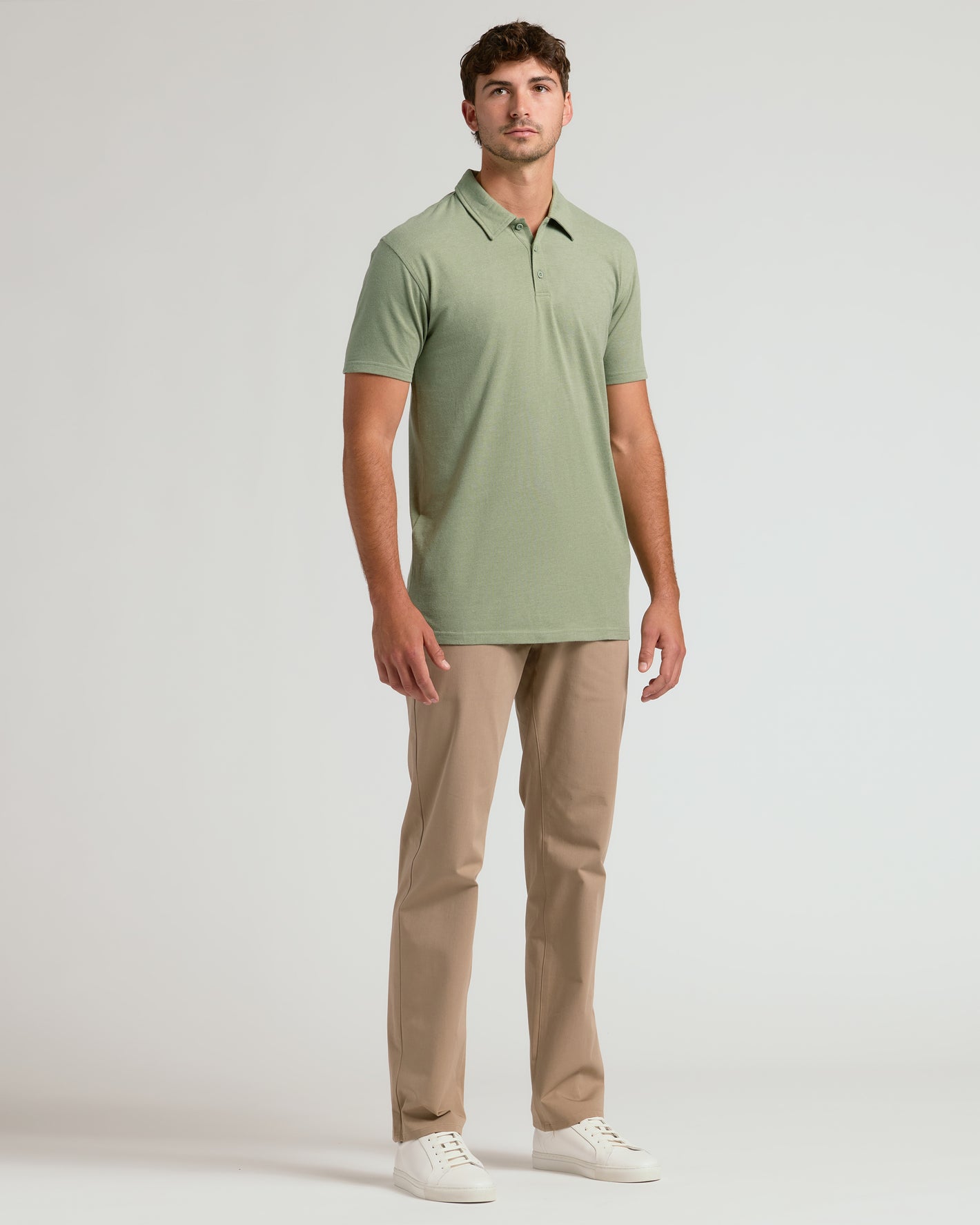 Man in Dark Heather Bay Green Short Sleeve Tall Polo, khaki trousers.