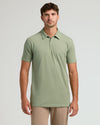 Model wearing Dark Heather Bay Green Short Sleeve Tall Polo, paired with khaki trousers.