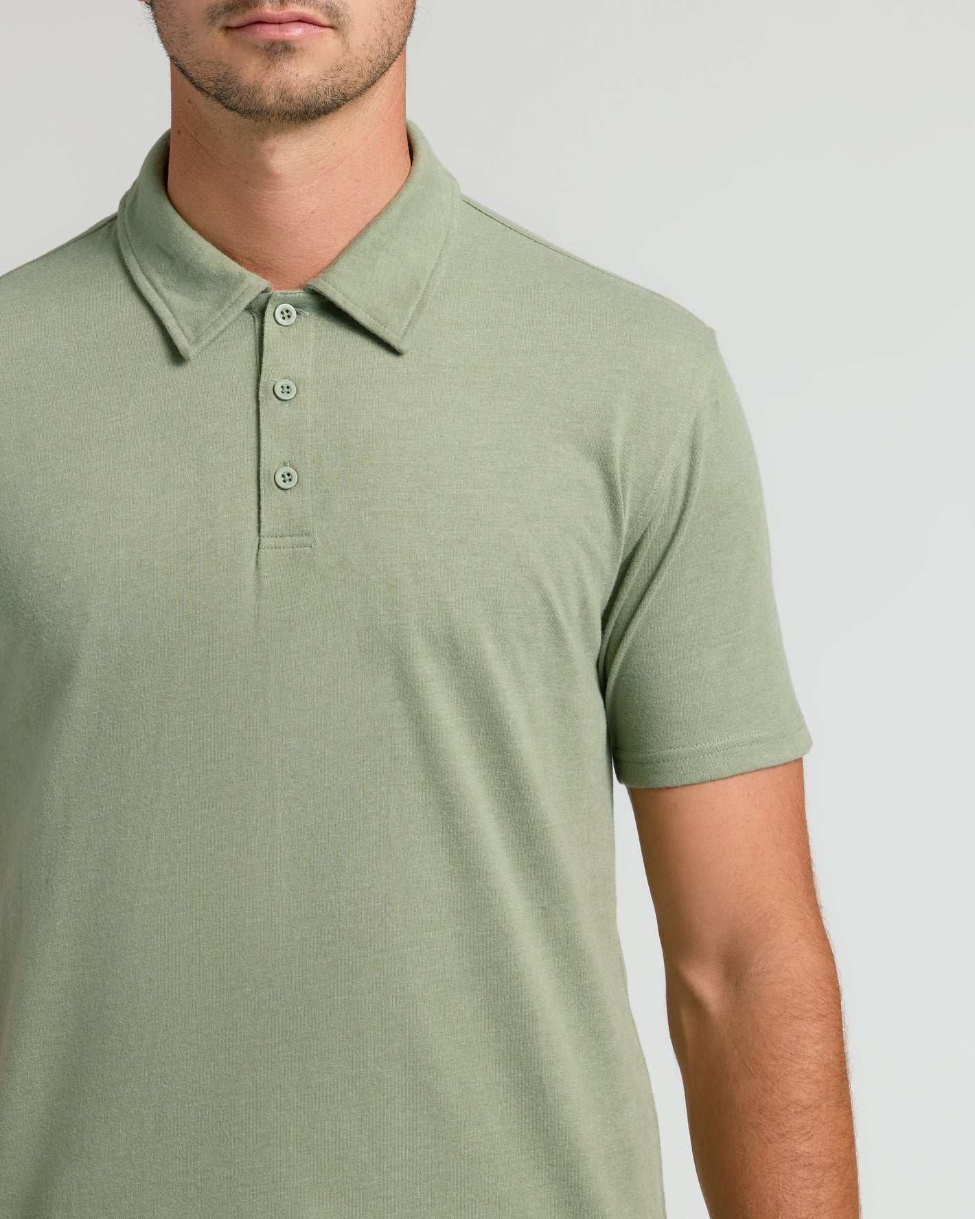 Man in Dark Heather Bay Green Polo, showcasing collar and texture.