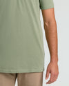 Person wearing Dark Heather Bay Green Short Sleeve Tall Polo and khaki pants.
