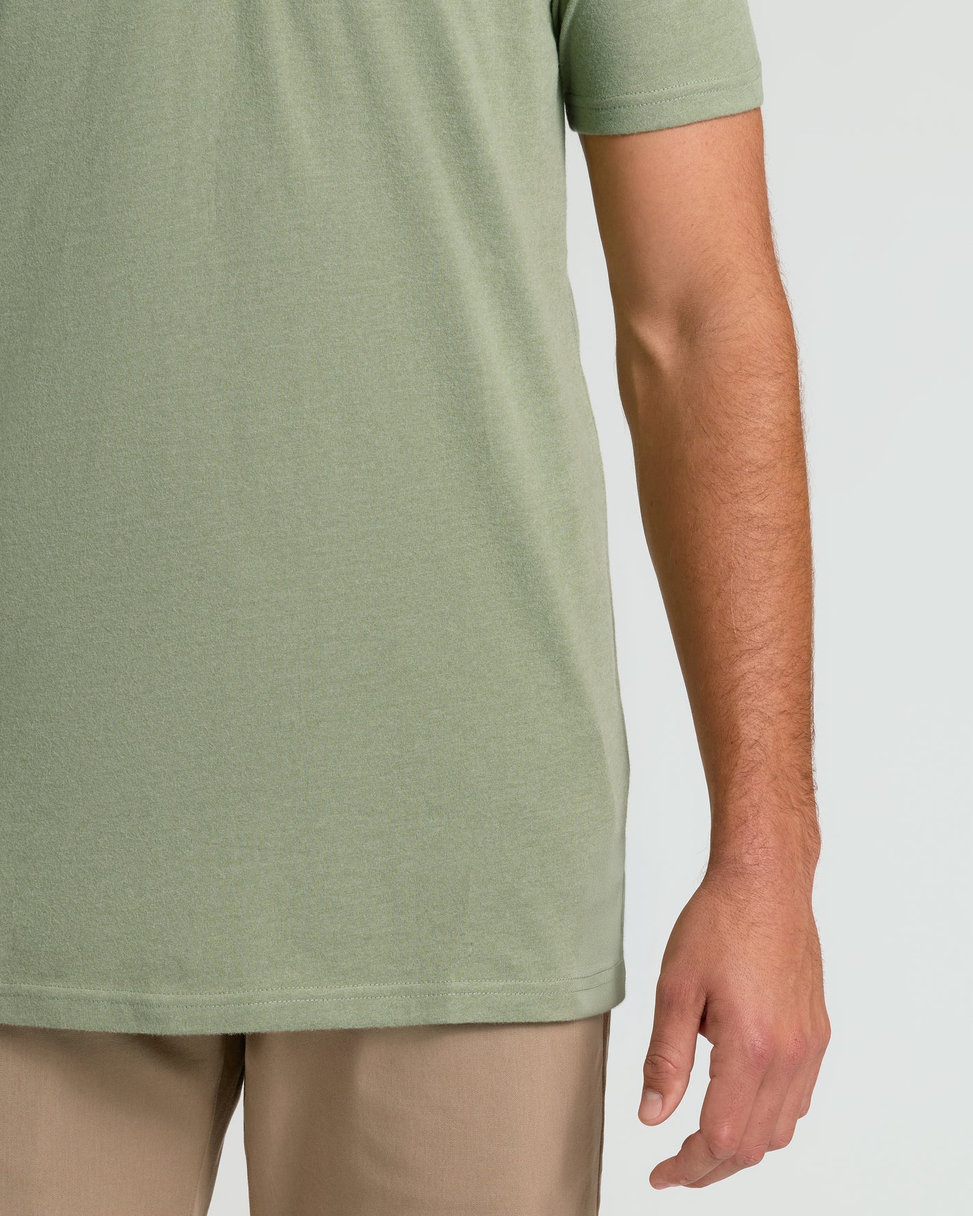 Person wearing Dark Heather Bay Green Short Sleeve Tall Polo and khaki pants.