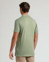 Man wearing Dark Heather Bay Green Short Sleeve Tall Polo, showcasing its fit.