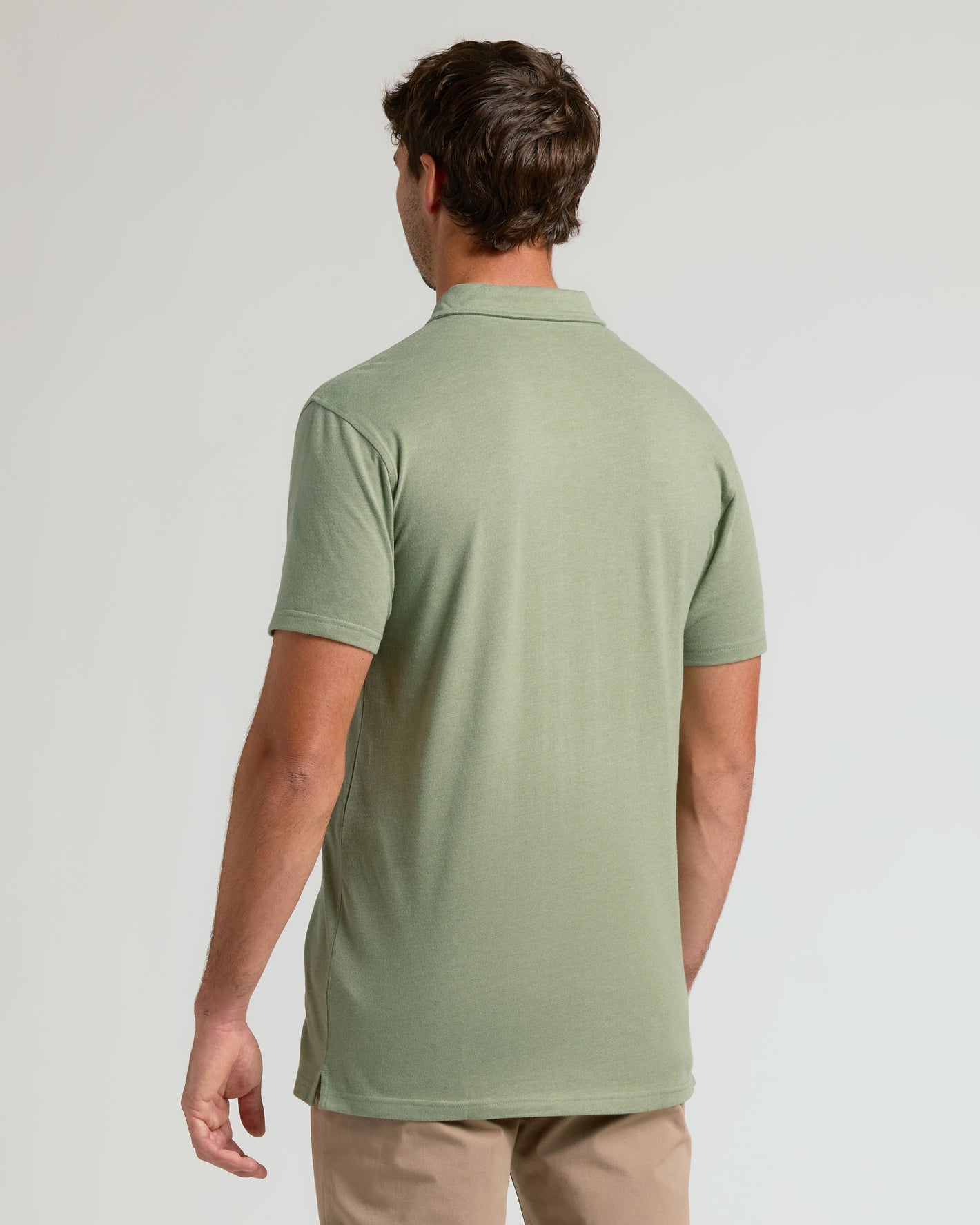 Man wearing Dark Heather Bay Green Short Sleeve Tall Polo, showcasing its fit.