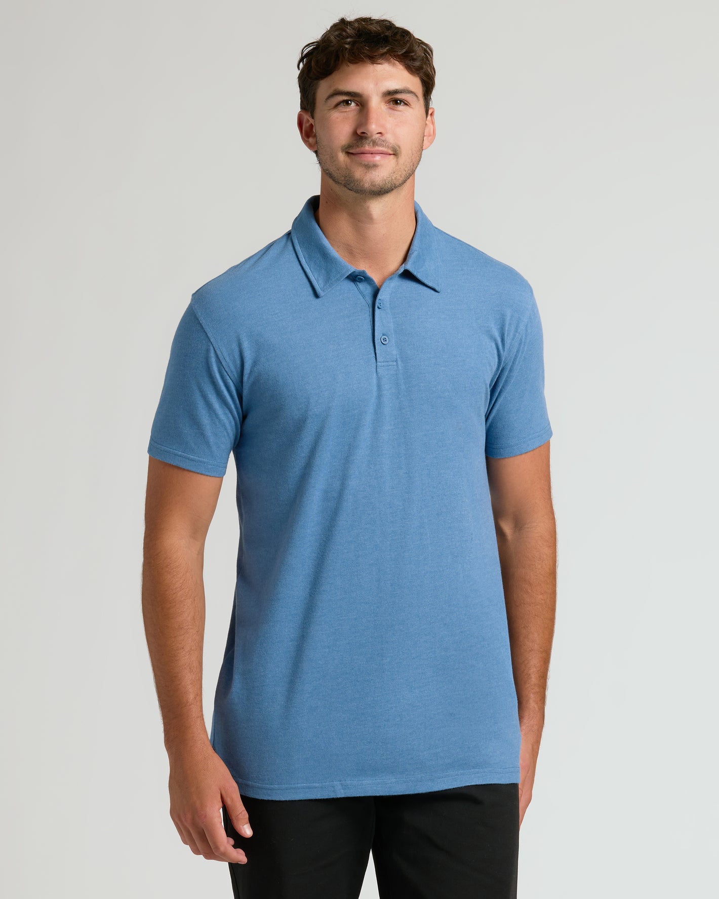 Man in Seasonal Tall Classic Polo 6-Pack, heather-blue, relaxed pose.