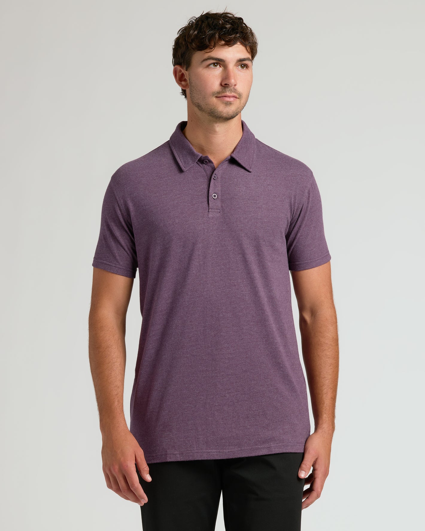 Young man in Dark Heather Plum Short Sleeve Tall Polo.