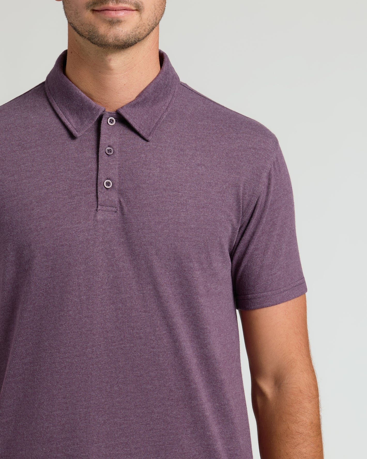 Man wearing Dark Heather Plum Short Sleeve Tall Polo, showing classic collar and placket.