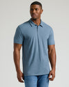 Man in Dark Heather Tempest Short Sleeve Tall Polo and jeans.