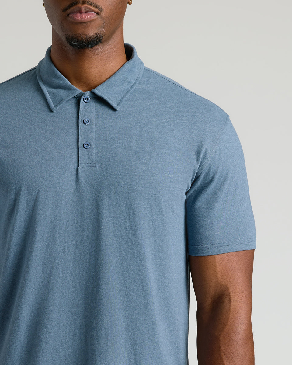 Man wearing Dark Heather Tempest Short Sleeve Tall Polo, highlighting collar and fit.