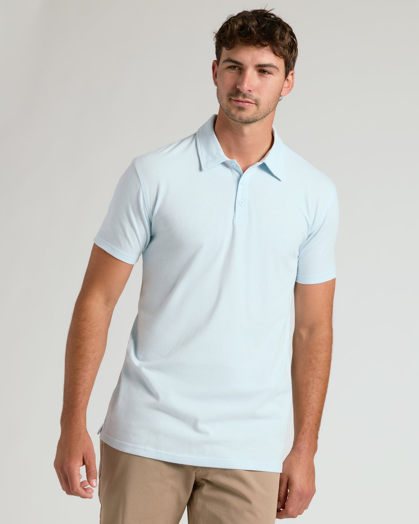 Man wearing Icicle Short Sleeve Tall Polo with khaki pants.
