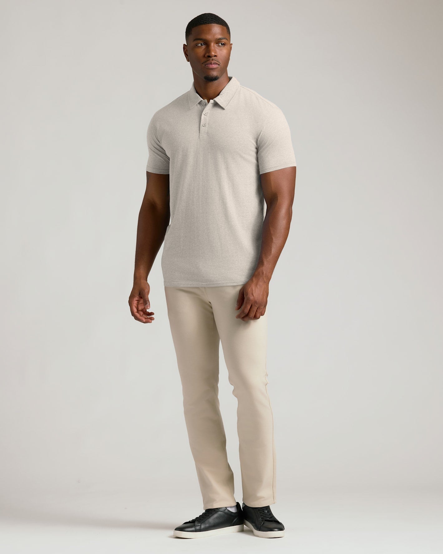 Seasonal Tall Classic Polo 3-Pack modeled by a man in beige.