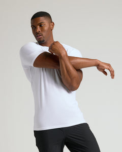 True ClassicWhite Tall Active Crew Neck 2.0 worn by athletic man stretching.