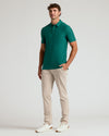 Model in Clover Short Sleeve Tall Active Polo, beige pants, white sneakers.