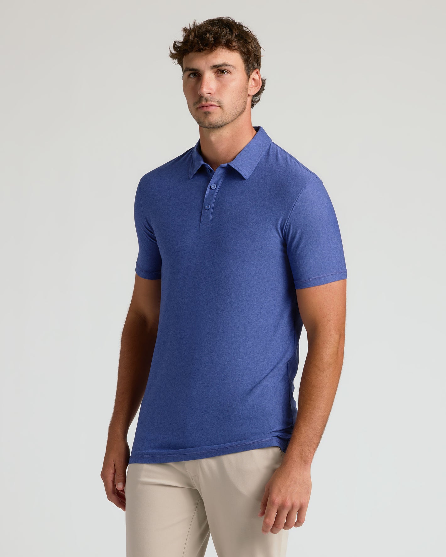 Cosmos Short Sleeve Tall Active Polo on young man, showcasing relaxed fit.