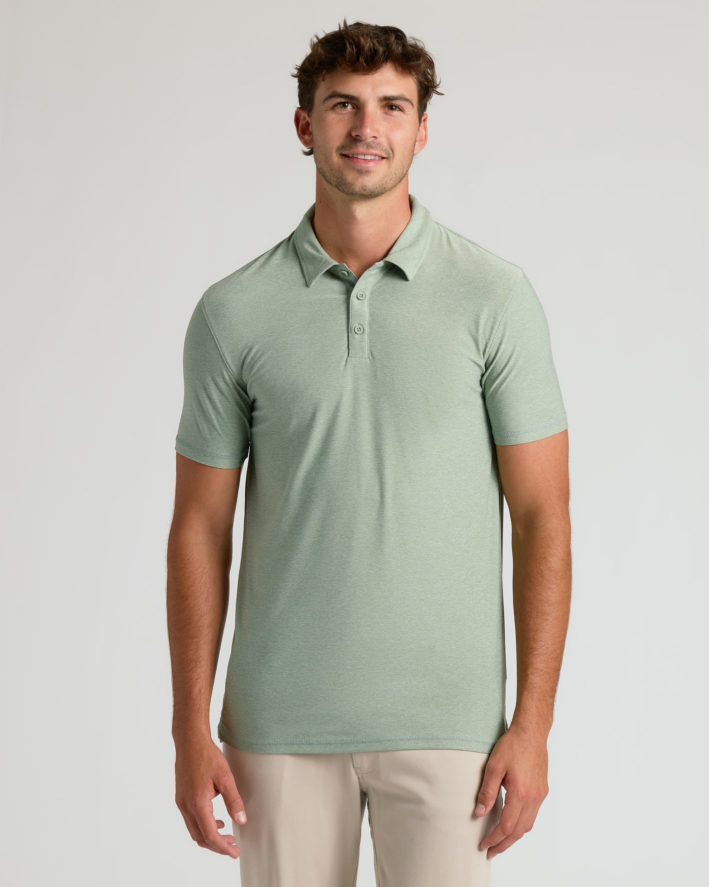 Young man wearing Limited Spring Tall Active Polo in light green.