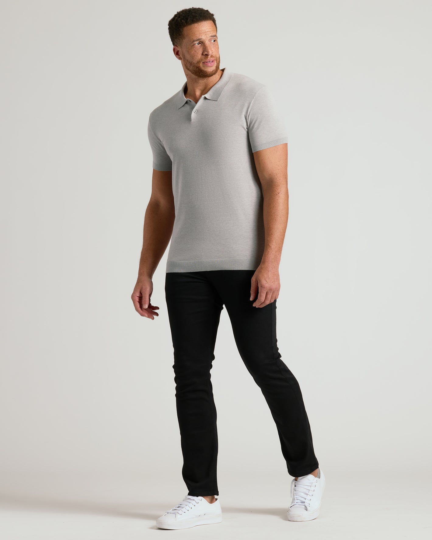 Man wearing Heather Gray Tall Dressy Polo with black pants and white sneakers.