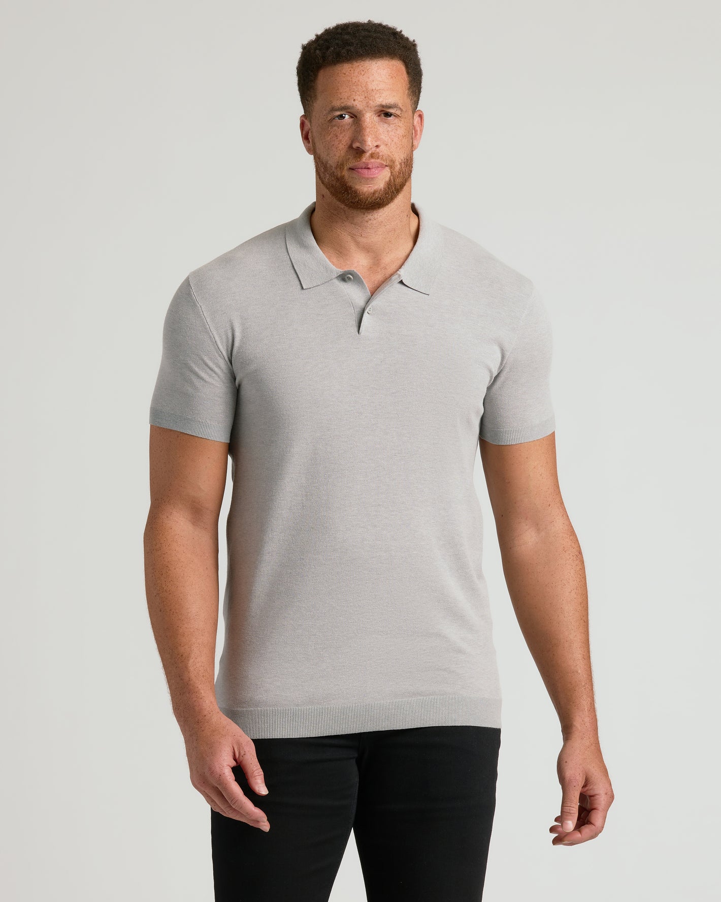 Man wears Heather Gray Tall Dressy Polo with slim-fit black pants.