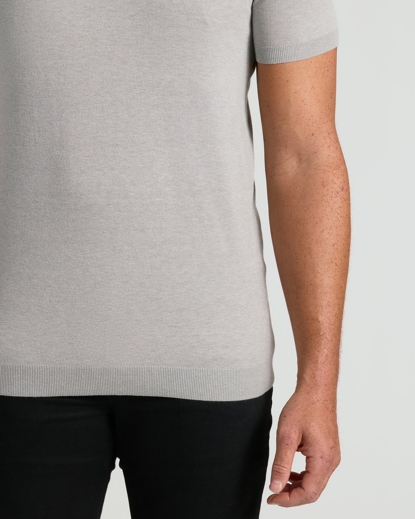 Heather Gray Tall Dressy Polo on person, highlighting ribbed hem and freckled arm.