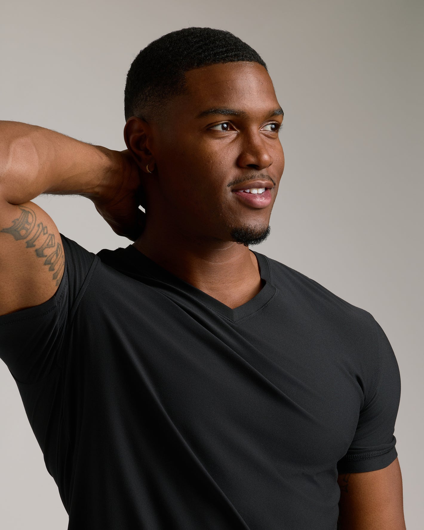 Young man wearing Black Tall Active V-Neck with tattoo visible.