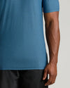 Dark Heather Bluebird Tall Active V-Neck worn by model against gray background.