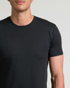 Close-up of a man wearing a black Tall Pima Cotton Blend Curved Hem Crew 7-Pack t-shirt, showcasing a soft fabric and a comfortable, classic fit for men's basics.