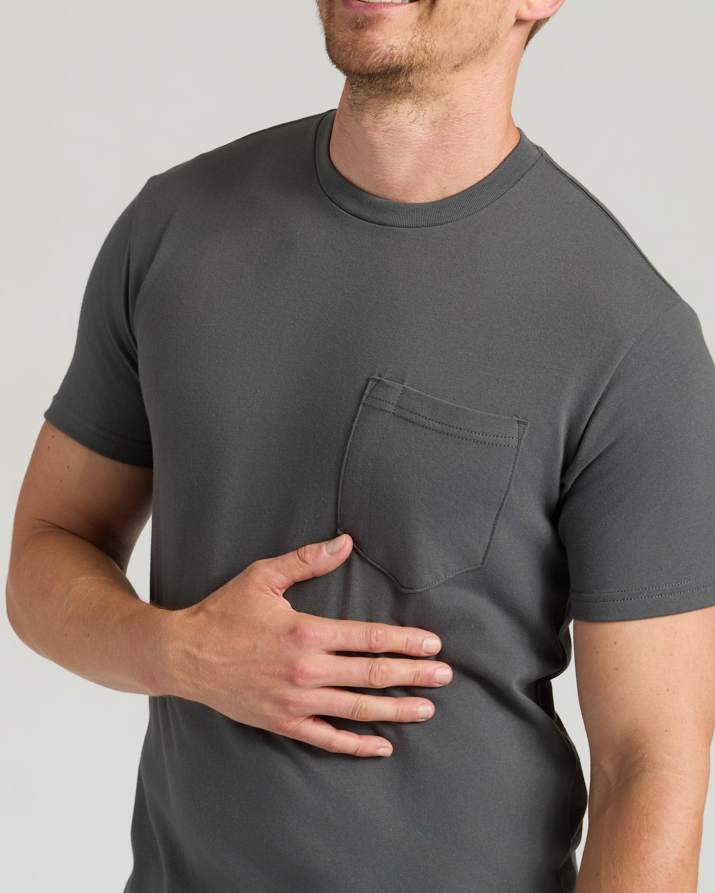 Staple Tall Heavyweight Pocket Crew worn by smiling person, highlighting chest pocket.