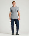 Man wearing Heather Gray Tall Heavyweight Pocket Crew, dark jeans, slip-on shoes.