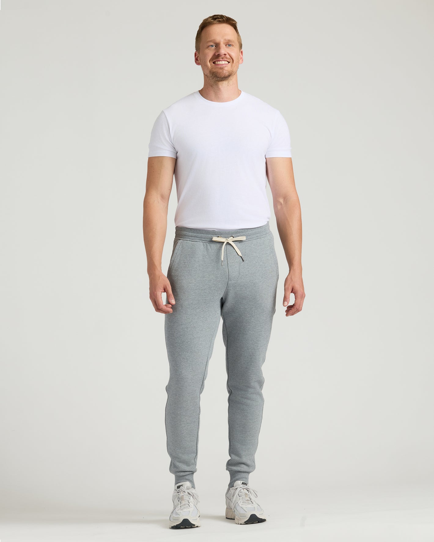 Man wearing Medium Heather Gray Tall Fleece French Terry Joggers.