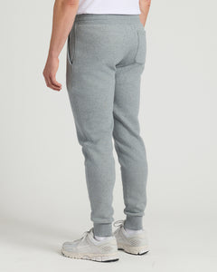 True ClassicMedium Heather Gray Tall Fleece French Terry Joggers with off-white sneakers.