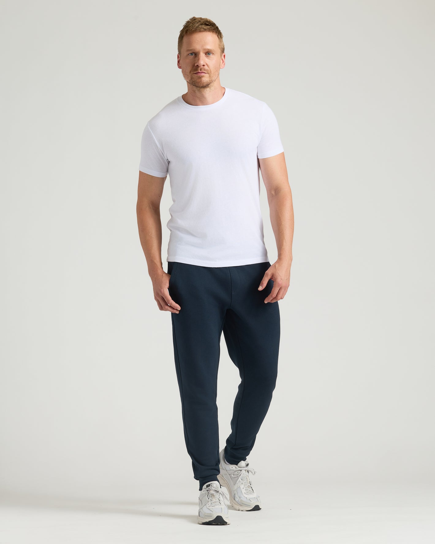 Tall male in Black & Navy Tall Fleece French Terry Joggers 2-Pack.