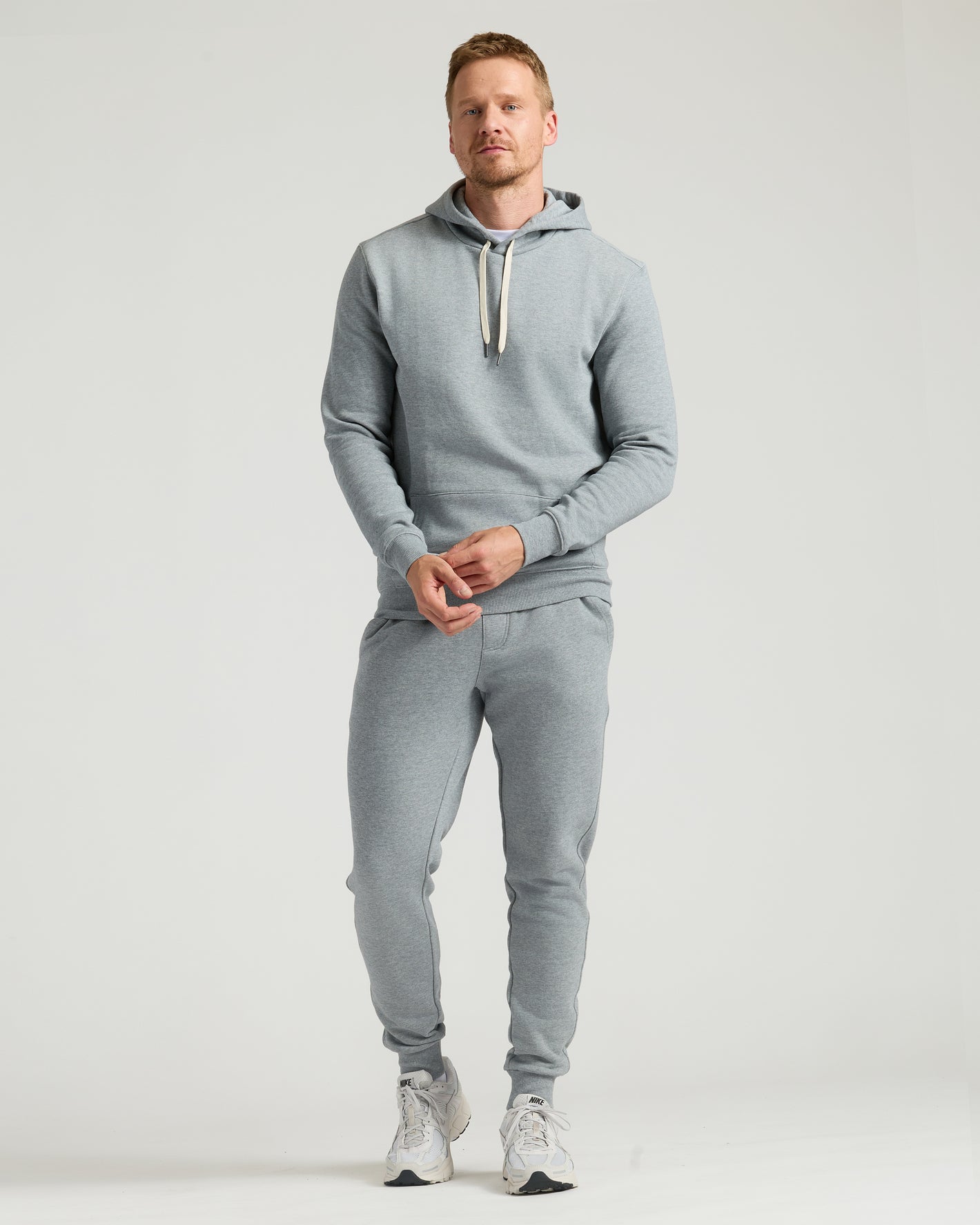 Medium Heather Gray Tall Fleece French Terry Pullover Hoodie on man standing.