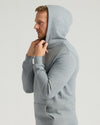 Side-profile of man wearing Medium Heather Gray Tall Fleece French Terry Pullover Hoodie.