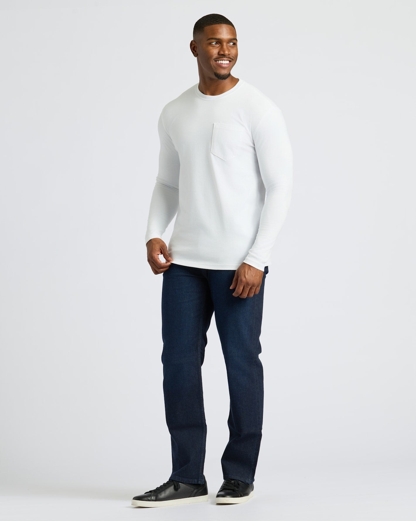 White Tall Heavyweight Long Sleeve Pocket Crew on smiling man in jeans.